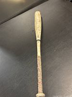 Full view of aluminum baseball bat showing overall condition and wear