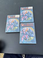 Three Aura Battler Dunbine VHS tapes laid on a dark surface showing front covers.