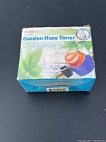 Box front with AM Conservation branding, product name 'Garden Hose Timer', and slogan 'Set it & Forget it!'