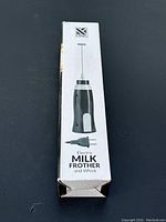 Front view of the original box showing image and product name 'Electric Milk Frother and Whisk'.