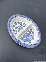 Full view of the oval divided dish showing two compartments and Blue Willow blue and white pattern.