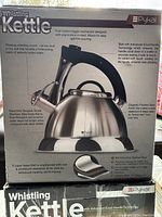 Box front showing features such as push button trigger, ergonomic handle, advanced cool-handle technology, 5 layer base, and surgical grade stainless steel body.