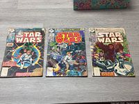Photo of three Star Wars comics issues 1, 2, and 3 displayed side by side showing front covers and overall poor condition.