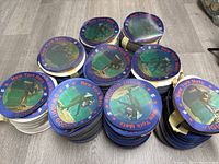 Multiple stacks of blue bordered circular lenticular hologram stickers featuring Dwight Gooden pitching for the New York Mets laid on a floor, showing quantity.