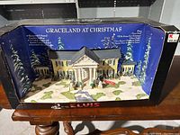 Full display set inside original box showing a winter snow scene with backing card and product details.