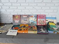 Front view of multiple military strategy board games with colorful tactical and war-themed cover art.