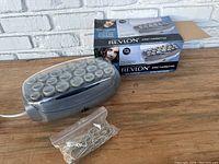 Revlon Ionic Hairsetter electric roller unit with 20 rollers shown along with original product box and plastic bag of metal hair pins.