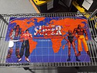 Front view of the Super Street Fighter II arcade header showing the full artwork and logo with characters on world map background