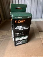 Closed box of Curt safety chain, showing packaging and product labeling with specifications and brand.