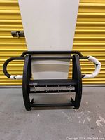 Front view of Aries Pro Series black steel grille guard with mesh panel and tubular design.