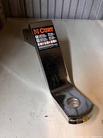 Chrome Curt ball mount placed on a white surface with label showing towing specs.