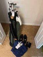 Full lot overview with golf bag, clubs, shoes, glove and tees