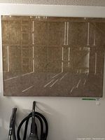 Full front view of large canvas art on frame showing abstract geometric design in beige and light brown hues.