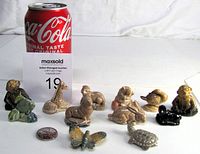 Sets of 12 Red Rose Wade animal figurines in various poses and glazes, photographed side by side with a soda can for scale, showing all figurines arranged in two rows.