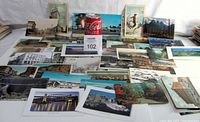 Lot of 42 mixed Canadian postcards spread out on table, showing various cityscapes, landmarks, and landscapes.