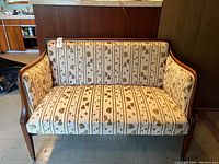 Front view showing the sofa's upholstery and wooden frame.