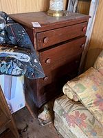 Brown wood dresser with scratches and wear, three drawers with round wooden knobs, approx 36 inches wide