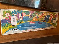 Full view of the colorful child's animal print wall art with various animals and nature scene