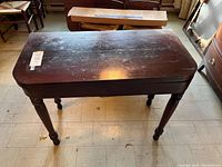 Full view of the wooden games table closed, showing the legs and overall structure.