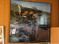 Image of the framed landscape print showing various plants and flowers with mountains in the background.