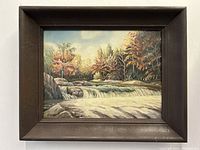 Frontal view of the framed waterfall landscape painting showing detailed composition and colors.