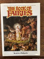 Front cover of 'The Book of Fairies' showing detailed fantasy painting with fairies, mythical creatures, and a fire, with text by Beatrice Phillpotts.