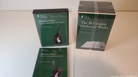 Two sets of music courses from The Great Courses: "The 30 Greatest Orchestral Works" with four volumes and "Elements of Jazz" with a green case and guidebook