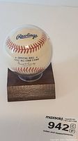 Front view of the official Rawlings baseball showing printed text 'Official Ball 1991 All-Star Game' inside a clear protective case on a wooden display base.