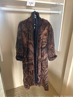 Front view of full-length coat hanging on rod