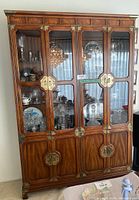 Front view of Henredon hutch showing four glass doors with display contents and lower storage panels