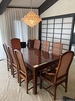 Full dining table set with six side chairs and two arm chairs in room