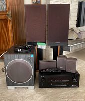 Overview of all components: subwoofer, satellites, receiver, remote, Mordaunt-Short speakers and stands