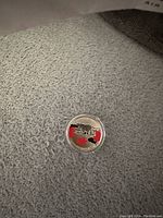 Photo of the coin's polar bear design with red maple leaves on the obverse side.