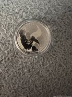 Obverse side of the silver coin showing Superman in flight with cape and year 2015.