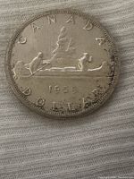 Close-up of the coin showing the canoe and paddlers with the year 1959 and text 'CANADA DOLLAR'