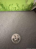 Photo of the coin front showing sailboat design, inscriptions Canada, 50 Dollars, and 2015