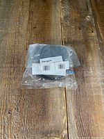 Sealed clear plastic bag containing a Targus notebook security lock with visible label showing brand and barcode.