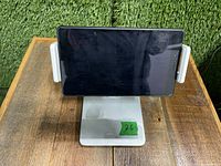 Front view of Kabcon tablet/phone holder stand with a tablet in horizontal position, showing padded grips and base