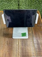 Front view of silver Kabcon tablet holder stand holding a tablet horizontally.