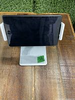 Tablet holder stand holding a tablet in landscape mode to show functionality and size.