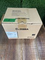 Closed original Zebra packaging box for the GX420d printer showing intact seal and box condition.