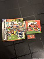 Photo showing the Mighty Beanz Pocket Puzzles game cartridge, original box, and manual for Game Boy Advance.
