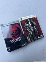 Front cover of Gears of War and Gears of War 2 game cases for Xbox 360 showing the artwork and titles