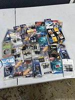 Photo shows a table with about 30 packages of various new car LED bulbs in their original packaging, including wedge, festoon, and bayonet types for automotive lighting.