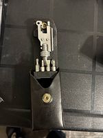 Leatherman multi-tool with multiple bits inserted, shown out of the sheath.