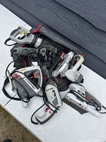 Overview of power tools arranged on a white table, showing saws, sander and blower