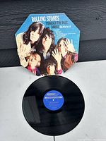 Image of the vinyl record and its octagonal jacket featuring The Rolling Stones