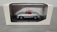 Front view of the Porsche 356 No. 1 1948 die cast model car enclosed in original packaging with clear plastic window.