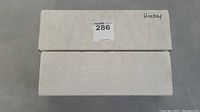 Two long white boxes labeled 'Hockey' containing the card lot.