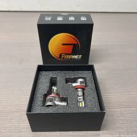 Two Forenner H11 LED bulbs in foam padded black box, viewed from above. The bulbs have visible LED chips and metal housing.